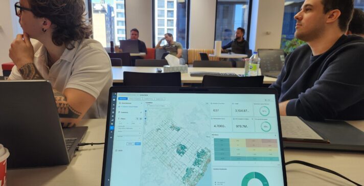 Asset investment planning model dashboard on a laptop showing a network map, condition scores, and a risk matrix.